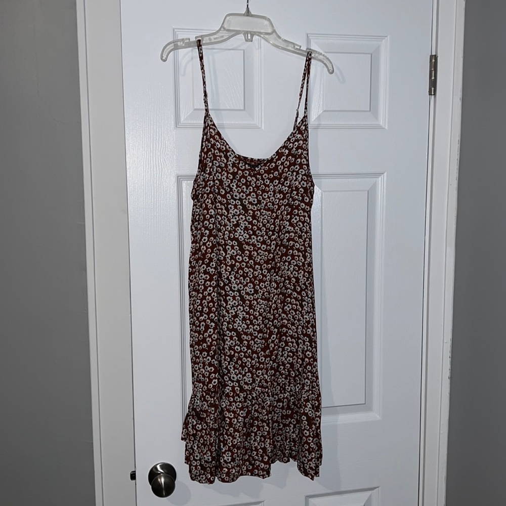 This is a red dress with white and blue flowers.